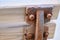 Wooden bench and its metal side exposed to corrosion