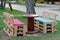 Wooden bench made of pallets for sitting with table made from coil of electric cable