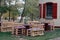 Wooden bench made of pallets for sitting with tables made from coil of electric cable