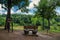 A wooden bench made with two barrels and a barbeque pit on a hill overlooking the Chattahoochee river