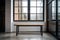 wooden bench with metal legs sits in front of black window industrial interior