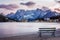 Wooden bench near famous tourist place Lake Lago di Misurina on sunset. picture with long e[posure and amazing dramatic sky