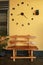 Wooden bench near yellow wall. Vintage wooden bench under the wall clock