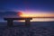 Wooden bench over beautiful tropical beach and magical twilight sunrise background