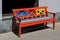 Wooden bench, painted in red, yellow and blue