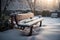 Wooden bench in the park covered with snow. Winter landscape.