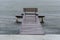 Wooden bench on a pier in front of the Conceicao Lagoon during a rainy day, in Florianopolis, Brazil