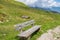 Wooden bench provided for hikers to rest while hiking at Zillertal Alps surrounded by mountains