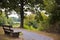 Wooden bench beside the road with a beautiful view of the lake s