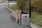 Wooden bench with rubbish bins in a public park.