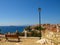 Wooden bench and street lamp with panoramic view over The Aegean Sea and Skiathos, Greece