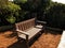 A wooden bench in a sunny Cape Town garden