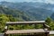 a wooden bench and View of Mountains from Ban Jabo Village in Northern Thailand