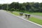 Wooden bench beside the walkway.