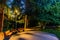 wooden benches in an empty night park, lit by the light of a street lamp