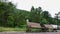 Wooden benches stand on the sidewalk in the park.