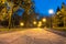 Wooden benches, street lights and park alley