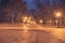 Wooden benches, street lights and park alley