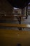 Wooden benches and tables under a shed in the yard.