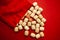 Wooden bingo kegs, on a red background in a red bag, for playing bingo. A way to spend time at home. 2021