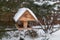 Wooden Bird feeder in the winter snow garden.