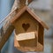 Wooden birdhouse. Bird feeder hanging on a tree. Bringing birds to the garden to protect against pests