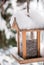 Wooden birdhouse covered with snow