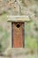 Wooden Birdhouse Hanging from a tree