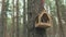 Wooden birdhouse hanging on tree in forest. Close-up of house for birds on branch of tree trunk.