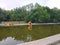 Wooden birdhouse in the middle of the pond in the park. Summer landscape in the park