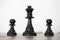 Wooden black queen and two pawns chess pieces