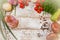 On a wooden bleached tabletop lies a set of vegetables for cooking