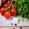 On a wooden bleached tabletop lies a set of vegetables for cooking