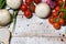 On a wooden bleached tabletop lies a set of vegetables for cooking