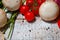 On a wooden bleached tabletop lies a set of vegetables for cooking