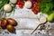 On a wooden bleached tabletop lies a set of vegetables for cooking