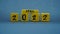 Wooden block calendar for April 2022. Yellow on a dark background
