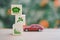 wooden block with co2 reduction icon concept and blurred miniature car  for CO2 emission ,green industries business . Net