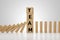 Wooden block domino effect stopped by wooden block stack with text TEAM. business crisis effect risk protection, business solution