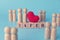 A wooden block with a message written on February 14, representing the Valentine`s Day. couple of doll wood with red hearts and