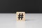 Wooden block number sign,hashtag symbol,pound sign on cement table black background wood cube concept