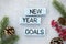 wooden block with text 2022 NEW YEAR GOALS on table background. Resolution, strategy, solution, business and holiday