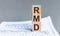 Wooden block with words RMD - acronim RMD - Required Minimum Distributions. Concept image of Accounting Business Acronym RMD