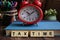 Wooden block written with TAX TIME inscription with calculator, magnify glasses, notebook and flower.  Selective focus. May have