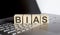 Wooden blocks with BIAS text of concept on laptop