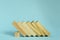 Wooden blocks on blue background. domino effect in business concept