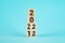 Wooden Blocks With changing number 2021 2022. New year concept. Copy space. Cube block flipping from 2021 to 2022 on a