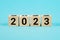 Wooden Blocks With changing number 2022 2023. New year concept. Copy space. Cube block flipping from 2022 to 2023 on a