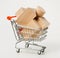 wooden blocks for the construction in shopping trolley  on a white
