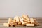 Wooden blocks disrupted on grey wooden background